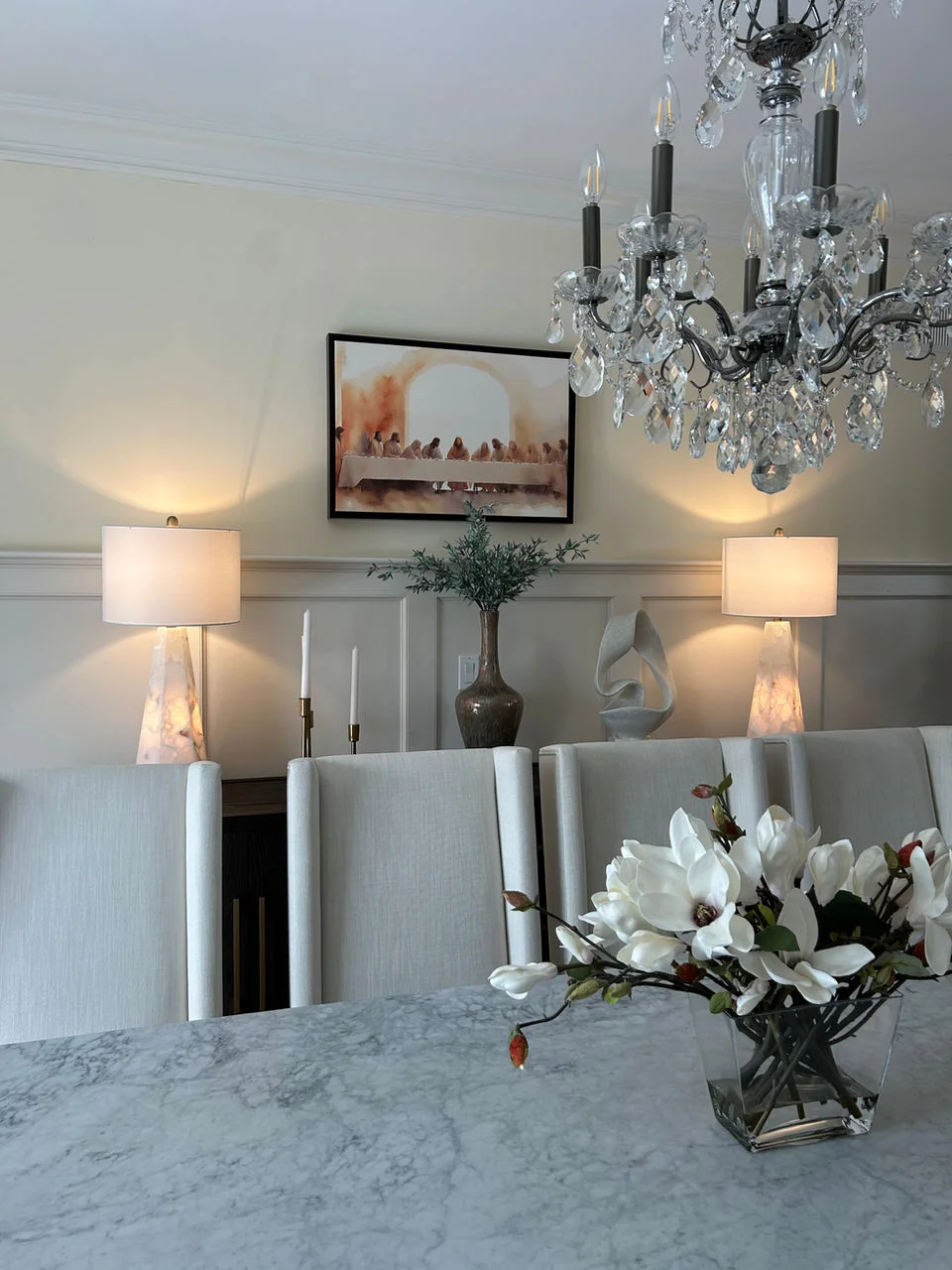 dining room modern elegant with last supper painting and chandelier